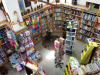 A photograph of a robustly stocked bookstore from above