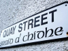 A photograph of a sign that reads (in English) Quay Street with the Gaelic translation printed below
