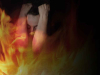 A photo collage of a human figure in emotional distress with fire superimposed over them