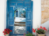 A blue door open before the viewer, revealing a courtyard within, in the city of Safed, Israel