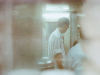 A gauzy photo of a waiter in Hong Kong working in a kitchen