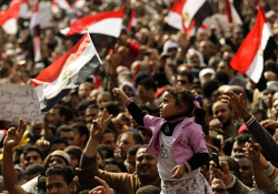 A girl waves the Egyptian national flag as thousands of demonstrators participate in antigovernment protests, February 8, 2011. Photo: Felipe Trueba / EPA / Thinking Images v.9