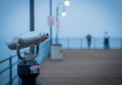 A photograph of pier binoculars, shrouded in fog