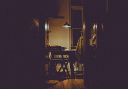 A photograph of a dimly lit nook in an apartment where a writing desk is set up