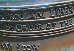 A detail from a photograph of the Liberty Bell. Incomplete text reads: Proclaim Liberty. By Order of the. . .