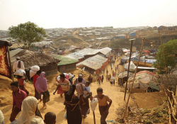 A photograph shot from a high vantage that shows refugees streaming in and out of the Kukupalong refugee camp