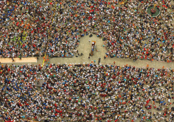 A photo shot from overhead of a crowd gathered in a square for a protest.