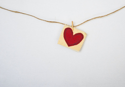 A photograph of a heart charm on a necklace