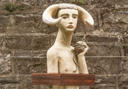 A sculpted bust of the minotaur, who seems boyish and frail