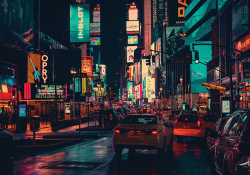 A dense urban scene with brightly colored signs lighting the night
