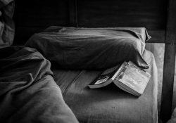 Open book on a bed. Photo by Steve Petrucelli